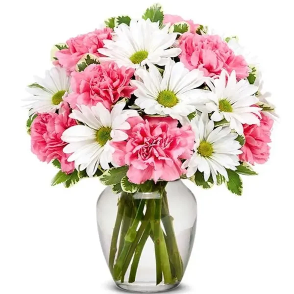 White daisies and pink carnations in a glass vase with variegated greenery