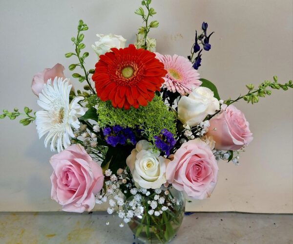 Local Cincinnati florist delivery bouquet with roses, daisies, gerbera blooms, and seasonal accents in a glass vase.
