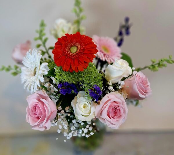 Local Cincinnati florist delivery bouquet with roses, daisies, gerbera blooms, and seasonal accents in a glass vase.
