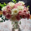 Handcrafted bouquet of white and blush‑pink roses with lush foliage, arranged in a clear vase and delivered fresh by a Cincinnati florist.