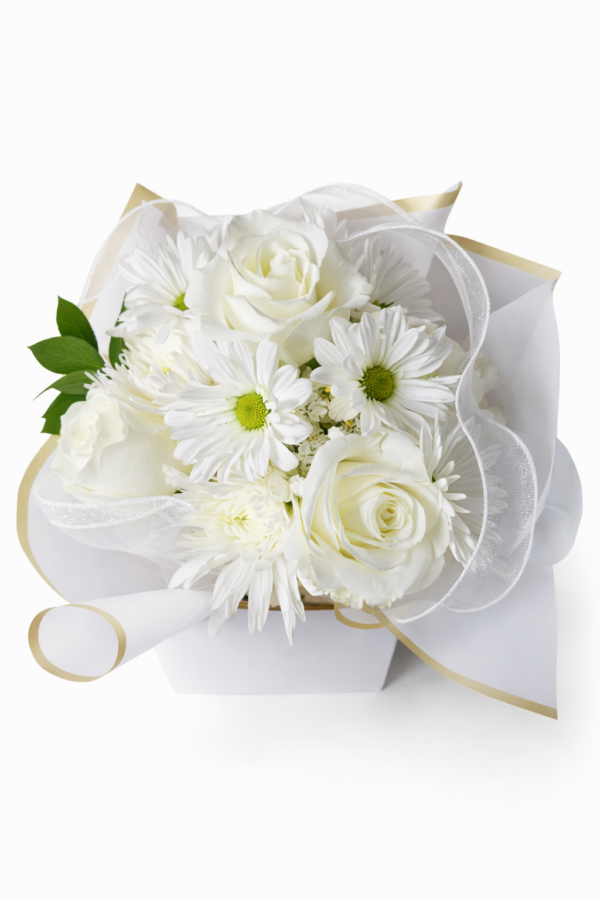 Celestial Ivory Charm Elegant white bouquet with roses, daisies, and greenery wrapped in gold‑trimmed paper and sheer ribbon