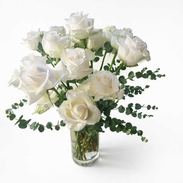 Fresh white roses with green foliage in a clear glass vase, symbolizing purity and sincerity, delivered by a local Cincinnati florist.