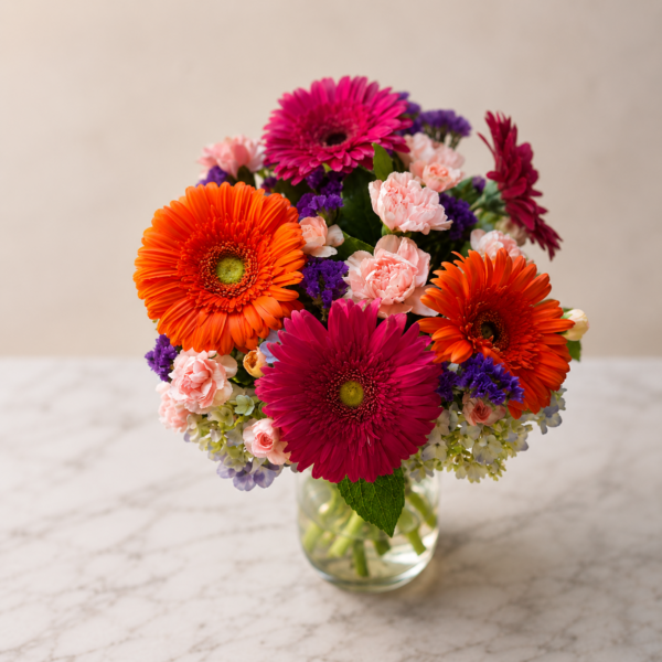 Chromatic Bliss Bouquet Chromatic Bliss Bouquet with gerbera daisies, carnations, hydrangeas, and statice in a clear vase, fresh delivery Cincinnati neighborhoods