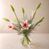 Growing and Glowin bouquet of lilies and seasonal blooms in a clear vase, symbolizing freshness and reliable flower delivery across Cincinnati and Northern Kentucky