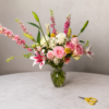 Closer Than Stars Closer Than Stars bouquet featuring roses, lilies, chrysanthemums, billy balls, and larkspurs in a clear glass vase, symbolizing freshness, secure delivery, and heartfelt storytelling across Cincinnati neighborhoods