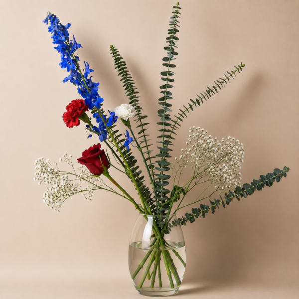 Americanos Bouquet with red roses, white carnations, blue delphinium, baby’s breath, and eucalyptus, handcrafted by local Cincinnati florist for delivery in Cincinnati and Northern Kentucky.
