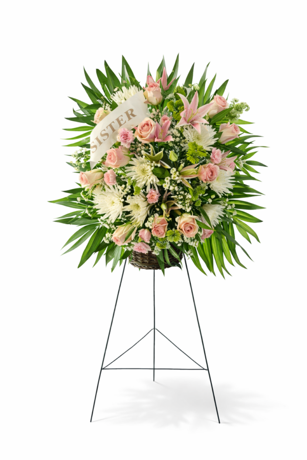Blossoms of Memory standing spray with pink roses, lilies, white chrysanthemums, and greenery on a black easel, honoring loved ones with elegance and care.