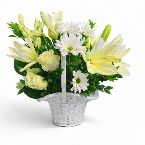 Cream Blossom Charm basket with soft yellow lilies, cream roses, white daisies, and lush greenery in a woven white basket.