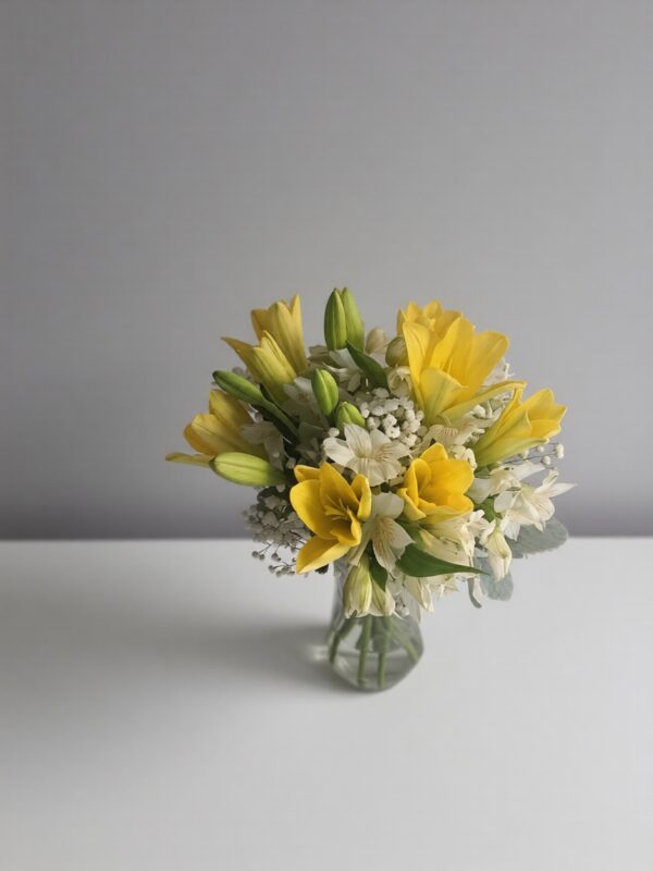 Fresh Start bouquet with yellow lilies, white alstroemeria, and greenery in a clear vase, delivered fresh across Cincinnati and Northern Kentucky.