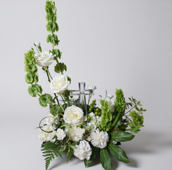 Heaven’s Light Cross floral arrangement with white roses, carnations, greenery, and a crystal cross, delivered fresh across Cincinnati and Northern Kentucky by allthepeoplesflowers.com