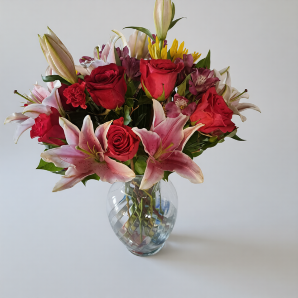 Love Bloom bouquet with red roses, pink lilies, and colorful accents in a clear glass vase, fresh flowers from Local Cincinnati Florist.