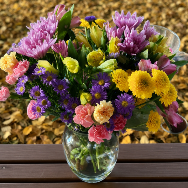 Lavender Sunshine Bouquet featuring fresh purple asters, yellow chrysanthemums, pink carnations, and seasonal blooms arranged in a clear glass vase with flower delivery in Cincinnati, Ohio.
