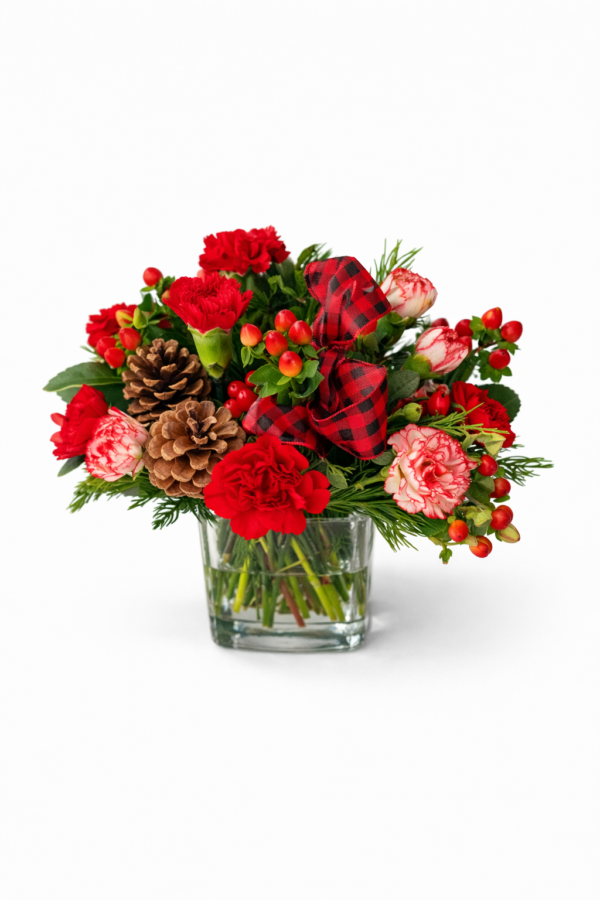 Snowberry Plaid vase with red and pink carnations, pinecones, red berries, greenery, and a plaid ribbon bow.