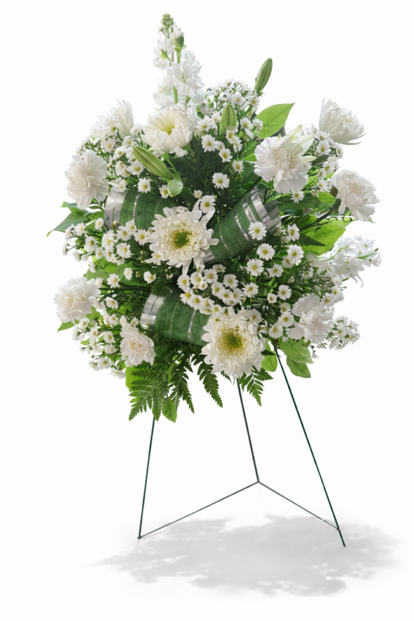 White Haven White Haven floral arrangement with white chrysanthemums, carnations, daisy‑like blooms, greenery, and silver ribbons on a stand