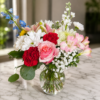 Cascading Joy Cascading Joy bouquet with roses, carnations, daisies, chrysanthemums, and alstroemeria arranged in a flowing design.