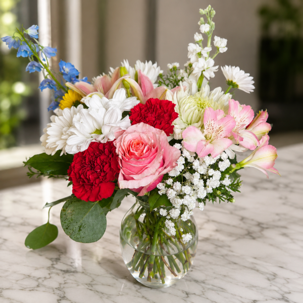 Cascading Joy Cascading Joy bouquet with roses, carnations, daisies, chrysanthemums, and alstroemeria arranged in a flowing design.
