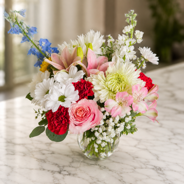 Cascading Joy Cascading Joy bouquet with roses, carnations, daisies, chrysanthemums, and alstroemeria arranged in a flowing design.