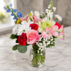 Cascading Joy bouquet with roses, carnations, daisies, chrysanthemums, and alstroemeria arranged in a flowing design.