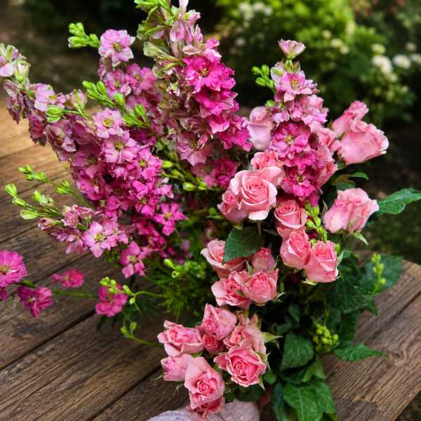 Crazy Beautiful bouquet of pink roses and magenta larkspur with lush greenery, handcrafted for freshness and reliable Cincinnati flower delivery.