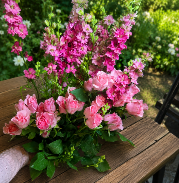 Crazy Beautiful bouquet of pink roses and magenta larkspur with lush greenery, handcrafted for freshness and reliable Cincinnati flower delivery.