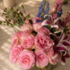 Liliana Smiles bouquet with pink roses, lilies, and accent blooms in a clear glass vase on marble surface, fresh floral arrangement for Cincinnati delivery