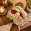 August in Ohio Bouquet with red roses, delicate buds, and lush greenery in a handcrafted arrangement on a wooden table.