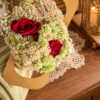 August in Ohio Bouquet with red roses, delicate buds, and lush greenery in a handcrafted arrangement on a wooden table.