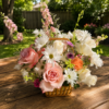Grand Lux wicker basket filled with roses, daisies, carnations, and seasonal blossoms, handcrafted for delivery in Cincinnati and Northern Kentucky.