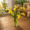 Bright yellow calla lilies in a clear glass vase on a rustic wooden table, handcrafted by allthepeoplesflowers.com for Cincinnati and Northern Kentucky flower delivery.